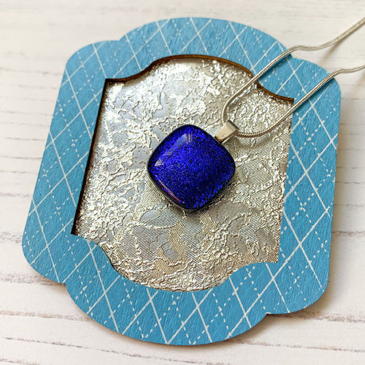 This ingenue blue handmade glass necklace is in multicoloured dichroic glass. It is a handmade necklace inspired by the princess in all of us!
