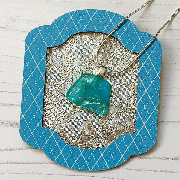 This ingenue aqua handmade glass necklace is in multicoloured dichroic glass. It is a handmade necklace inspired by the princess in all of us!