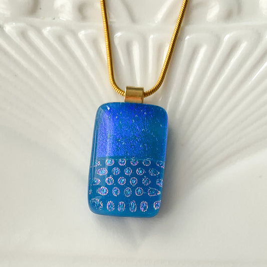 This geometric dotty glass necklace is a handmade necklace in colourful geometric patterns.