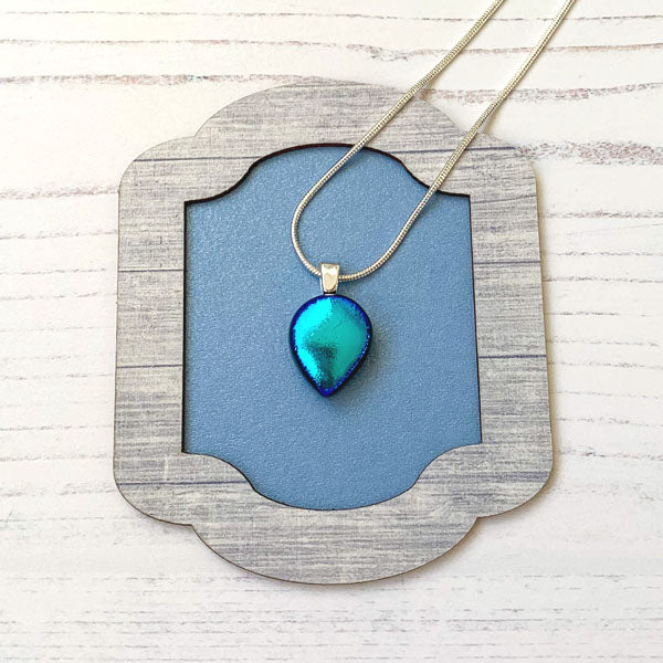 This ingenue teal glass necklace is in dichroic glass. It is a handmade necklace inspired by the princess in all of us!