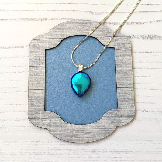 This ingenue teal glass necklace is in dichroic glass. It is a handmade necklace inspired by the princess in all of us!