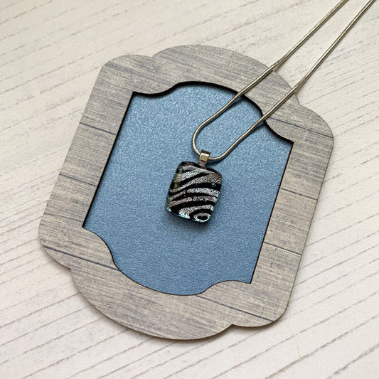 This ingenue purple zebra necklace is in multicoloured dichroic glass. It is a handmade necklace inspired by the princess in all of us!