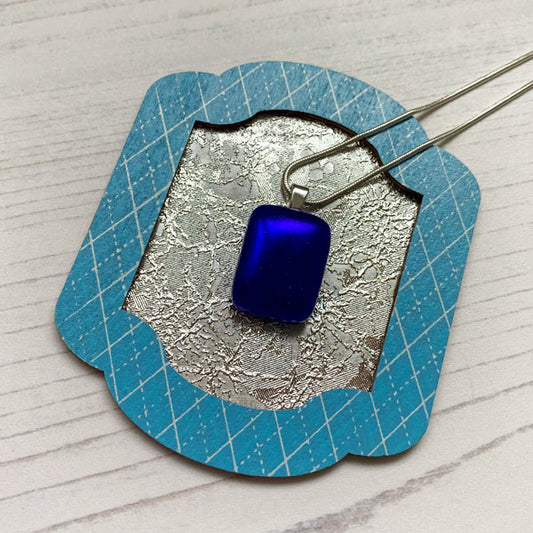 This ingenue blue glass necklace is in multicoloured dichroic glass. It is a handmade necklace inspired by the princess in all of us!