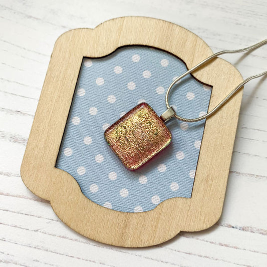 This ingenue pink handmade glass necklace is in multicoloured dichroic glass. It is a handmade necklace inspired by the princess in all of us!