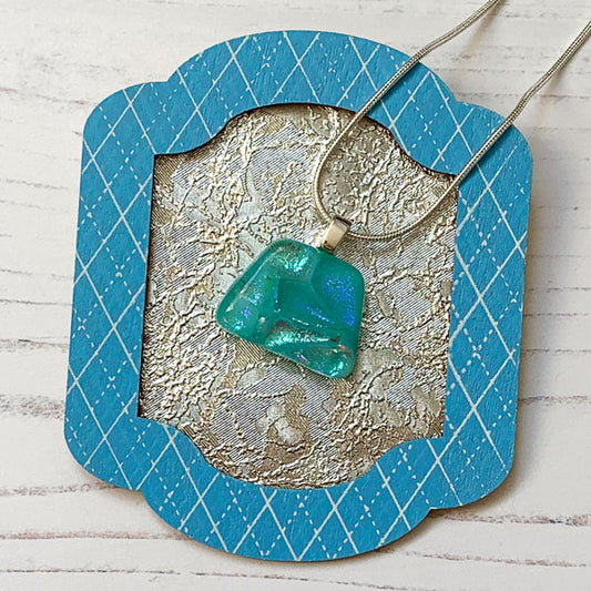 This ingenue aqua handmade glass necklace is in multicoloured dichroic glass. It is a handmade necklace inspired by the princess in all of us!