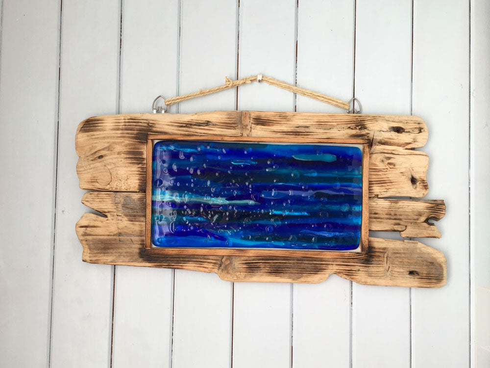 This blue sea dichroic artwork is handmade mounted on a unique handmade wooden frame. The artwork is inspired by my local beaches, I love how the sea changes colours during the different seasons.