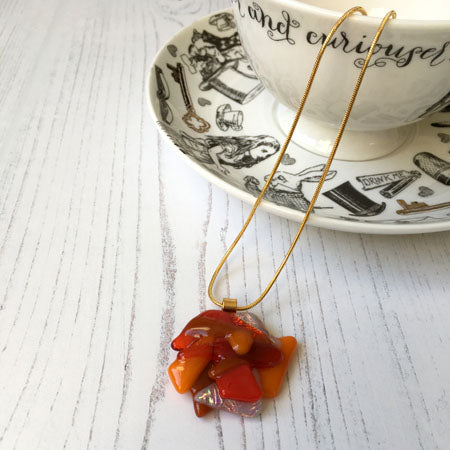 This orange signature dichroic glass necklace is a handmade necklace that is inspired by my favourite style of creating necklaces.