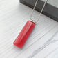 This pink classic glass necklace, in solid pink and has simple classic lines.