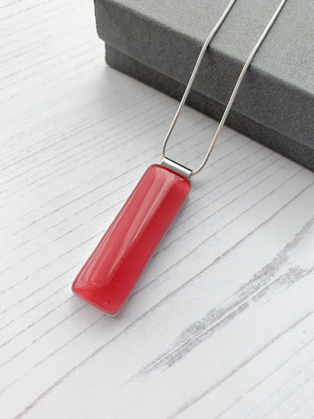 This pink classic glass necklace, in solid pink and has simple classic lines.