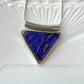 This geometric triangle dichroic glass necklace is a handmade necklace in colourful geometric patterns.