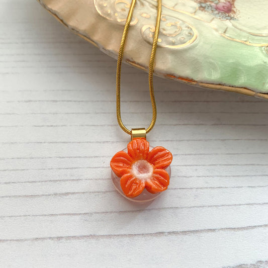 This orange flower necklace is inspired by the nature from my local Pembrokeshire countryside. Handmade in Wales. Comes with a chain.