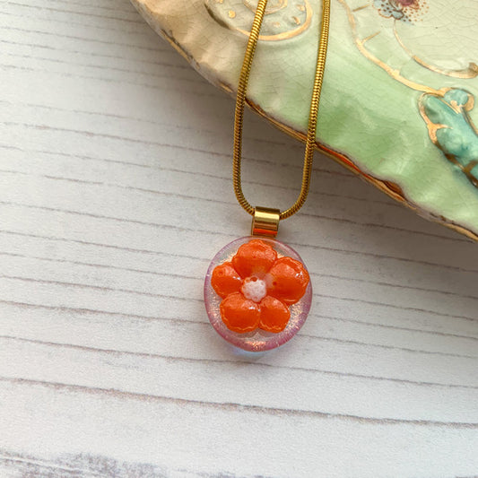 This orange dichroic flower necklace is inspired by the nature from my local Pembrokeshire countryside. Handmade in Wales. Comes with a chain.