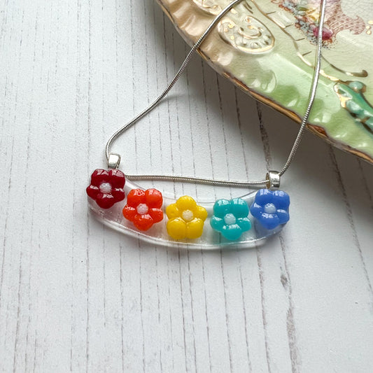 This rainbow flower necklace is inspired by the nature from my local Pembrokeshire countryside. Handmade in Wales. Comes with a chain.