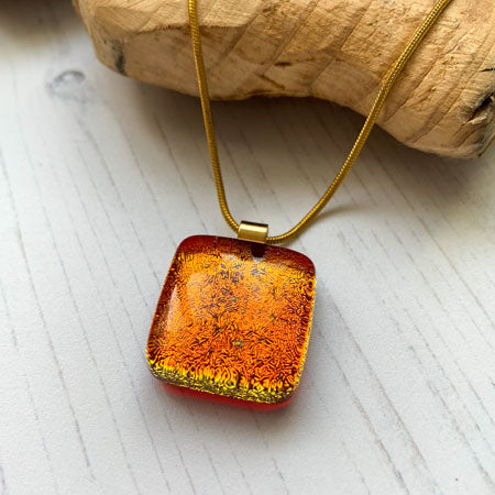 This twinkle orange necklace is a handmade necklace that I make with my favourite type of glass, dichroic.
