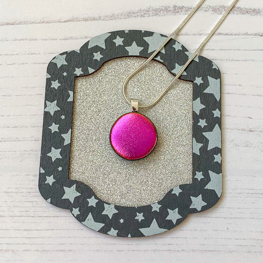 This round pink ingenue necklace is in dichroic glass. It is a handmade necklace inspired by the princess in all of us!