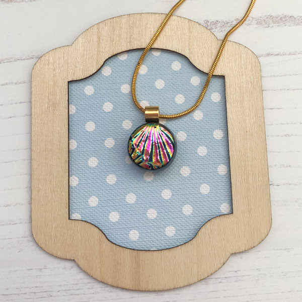 This ingenue copper necklace is in multicoloured dichroic glass. It is a handmade necklace inspired by the princess in all of us!