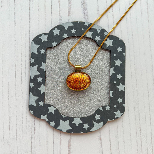 This ingenue copper necklace is in multicoloured dichroic glass. It is a handmade necklace inspired by the princess in all of us!